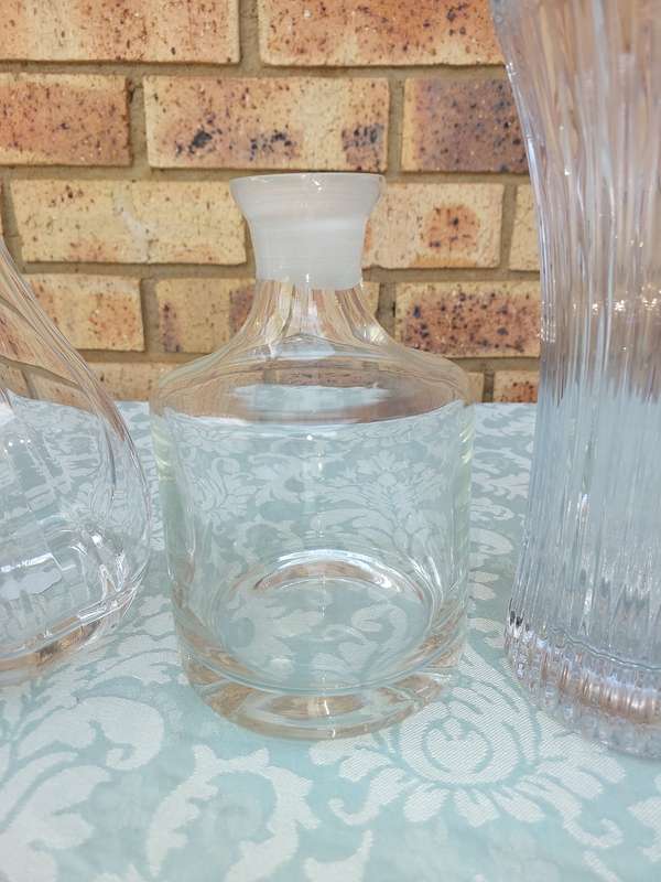 A vintage joblot decanters and vase sold as is