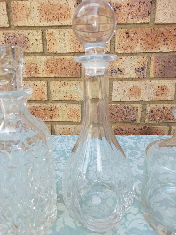 A vintage joblot decanters and vase sold as is