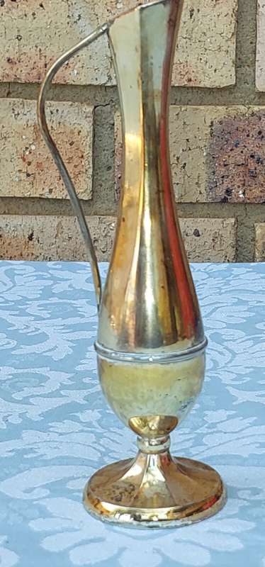 A SILVER PLATED FLOWER VASE SOLD AS IS