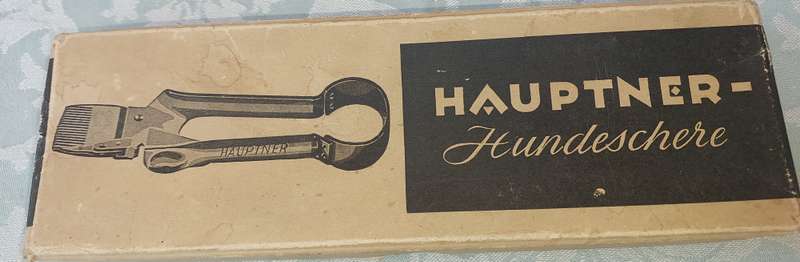 A VINTAGE HAUPTNER DOG SHERES WITH A METAL COMB IN ITS ORIGINAL BOX SOLD AS IS