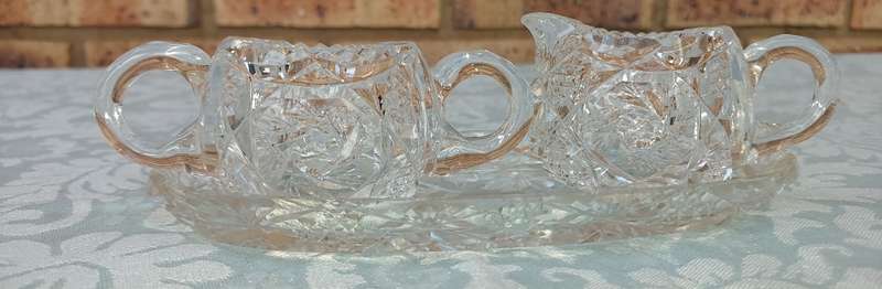 AN ART DECOR GLASS SUGAR BOWL AND A MILK JUG SOLD AS IS