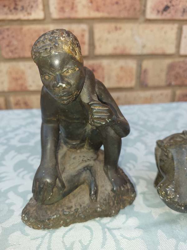 A COLLECTION OF AFRICAN HUNTER AND ANIMAL SCULPTURES SOLD AS IS
