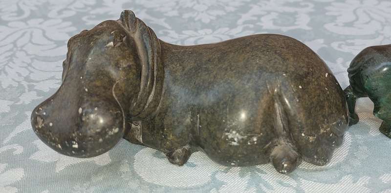 A COLLECTION OF AFRICAN HUNTER AND ANIMAL SCULPTURES SOLD AS IS