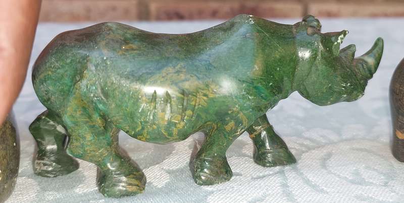 A COLLECTION OF AFRICAN HUNTER AND ANIMAL SCULPTURES SOLD AS IS