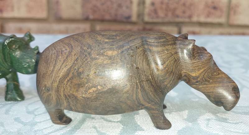 A COLLECTION OF AFRICAN HUNTER AND ANIMAL SCULPTURES SOLD AS IS