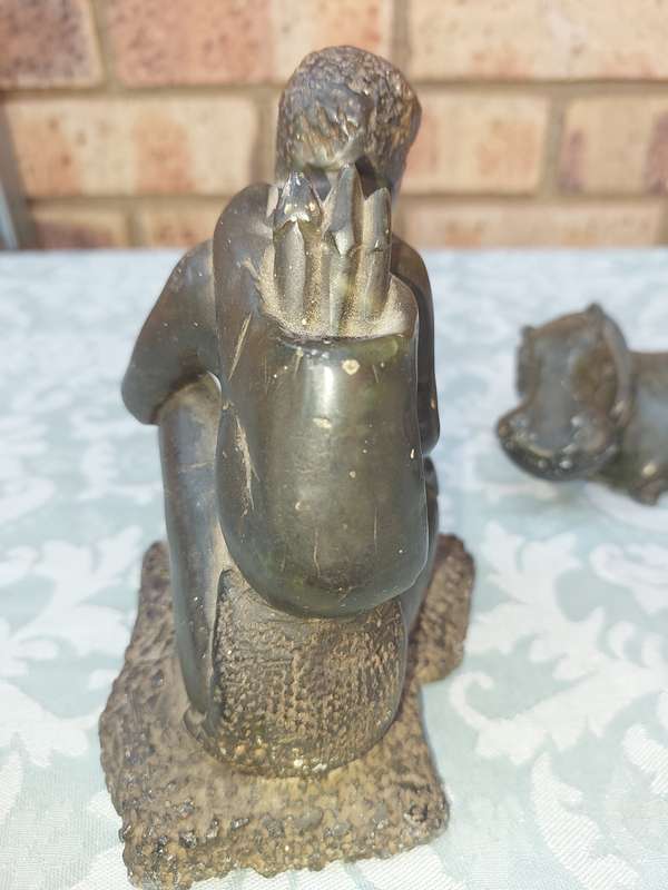 A COLLECTION OF AFRICAN HUNTER AND ANIMAL SCULPTURES SOLD AS IS