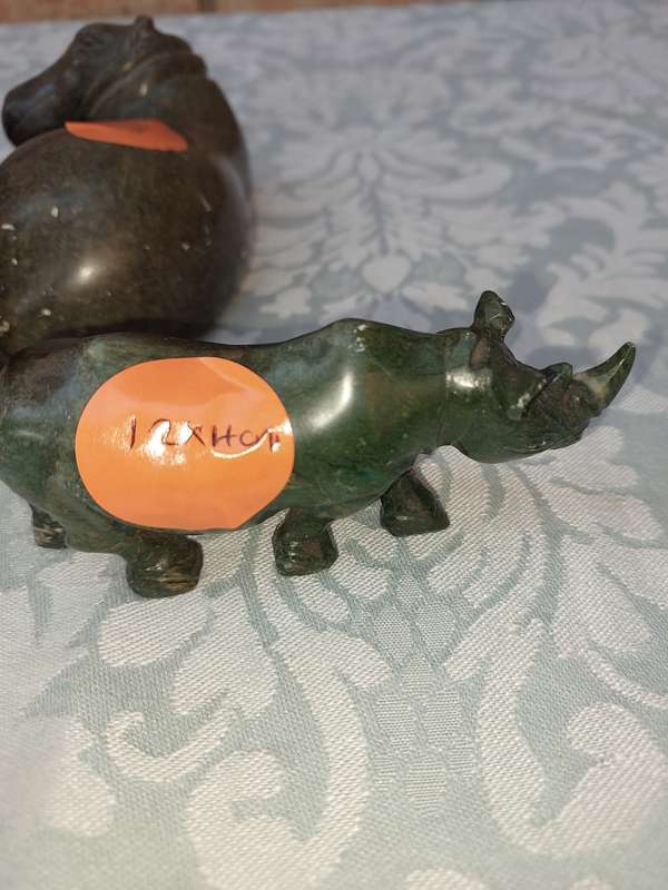 A COLLECTION OF AFRICAN HUNTER AND ANIMAL SCULPTURES SOLD AS IS