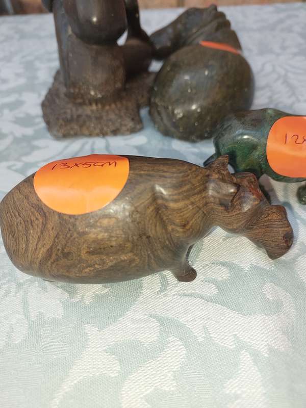 A COLLECTION OF AFRICAN HUNTER AND ANIMAL SCULPTURES SOLD AS IS