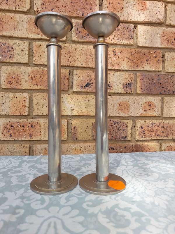 A PAIR OF ART DECOR SS CANDLE STANDS SOLD AS IS R200