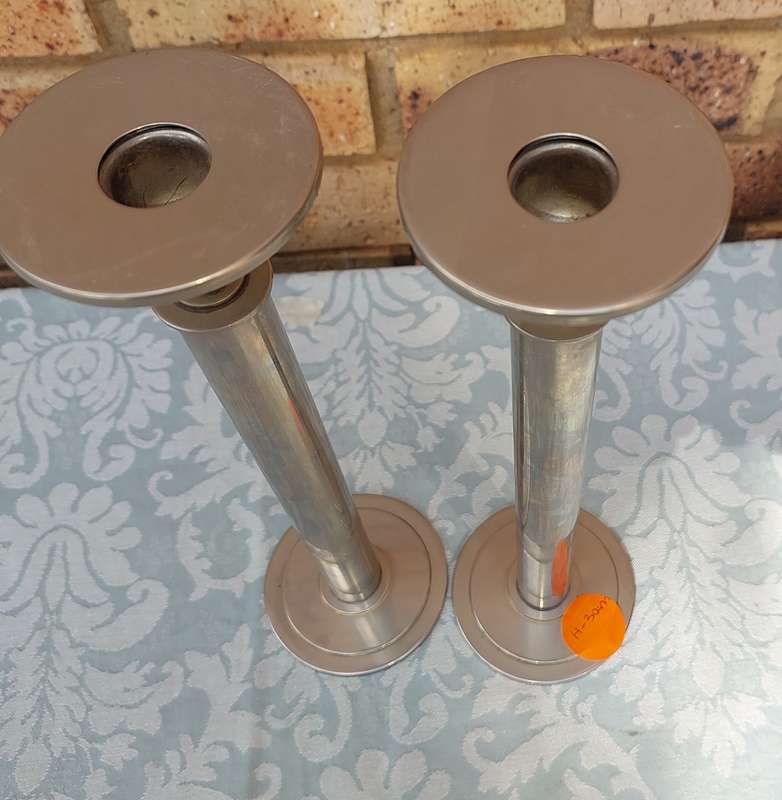 A PAIR OF ART DECOR SS CANDLE STANDS SOLD AS IS R200