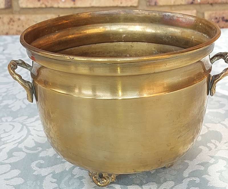 A VINTAGE BRASS FOOTED POTPLANT HOLDER SOLD AS IS R200