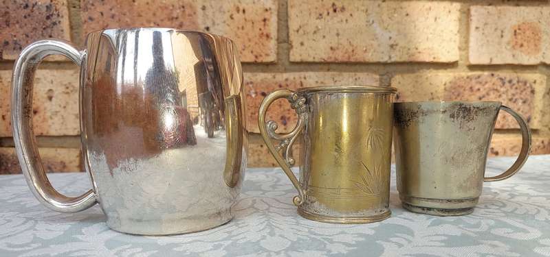 A COLLECTION OF SILVER PLATED BEER MUGS SOLD AS IS