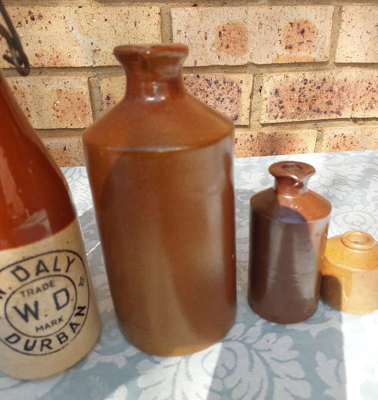 A COLLECTION OF ART DECOR STONE WARE STORAGE CONTAINERS SOLD AS IS R350