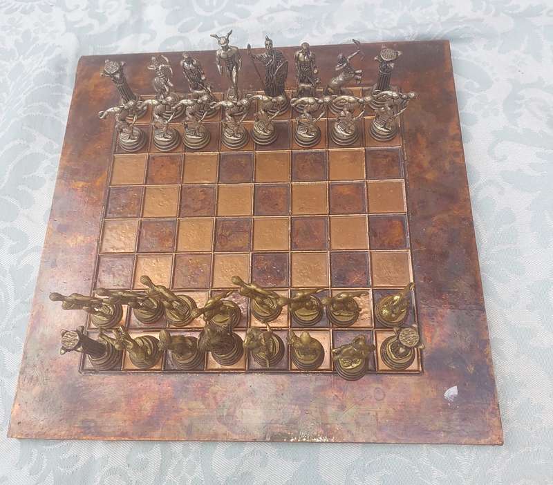 A VINTAGE COPPER AND BRONZE CHESS SET SOLD AS IS