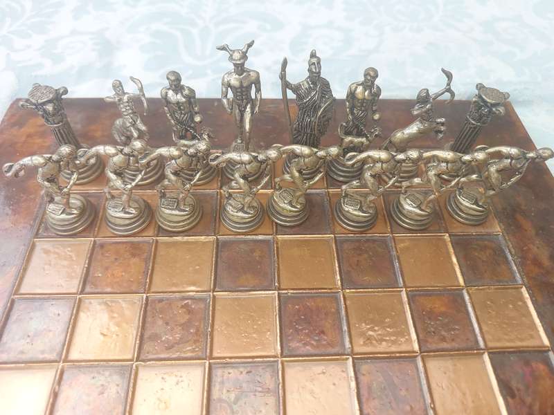 A VINTAGE COPPER AND BRONZE CHESS SET SOLD AS IS