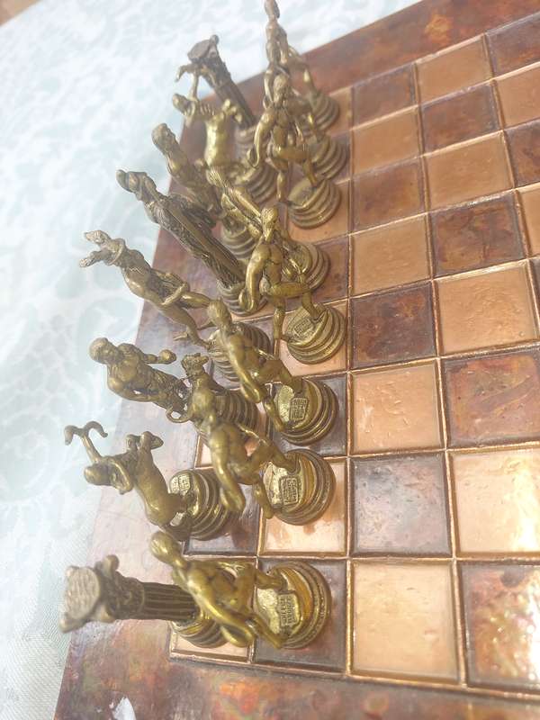 A VINTAGE COPPER AND BRONZE CHESS SET SOLD AS IS
