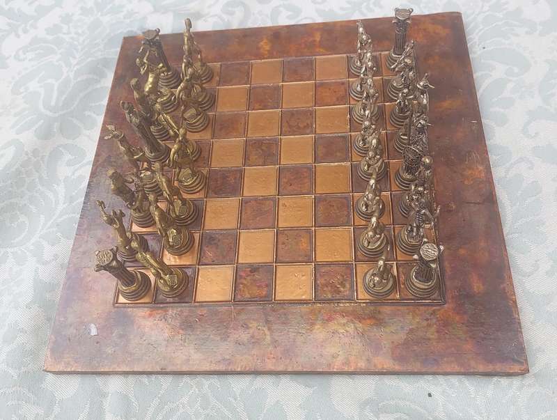 A VINTAGE COPPER AND BRONZE CHESS SET SOLD AS IS