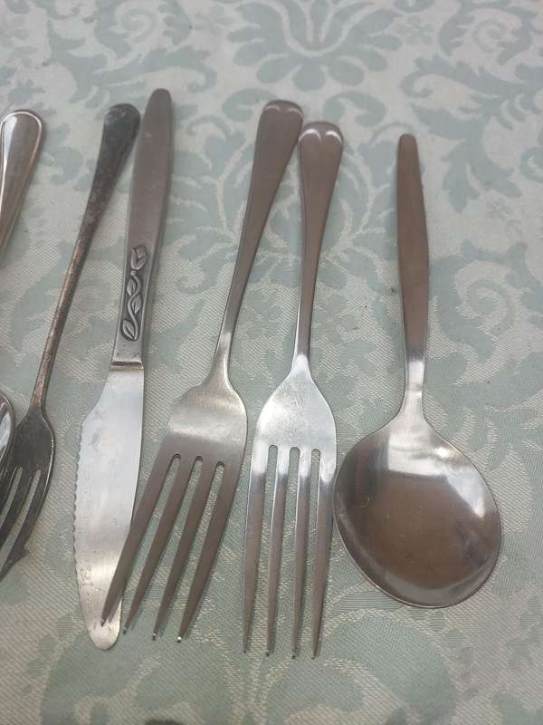 A VINTAGE JOBLOT MIXED CUTLERY SOLD AS IS