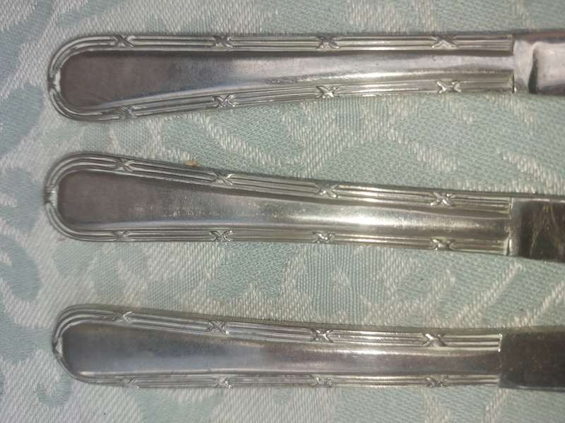 A VINTAGE SET OF NICKEL SILVER SHEFFIELD KNIVES SOLD AS IS