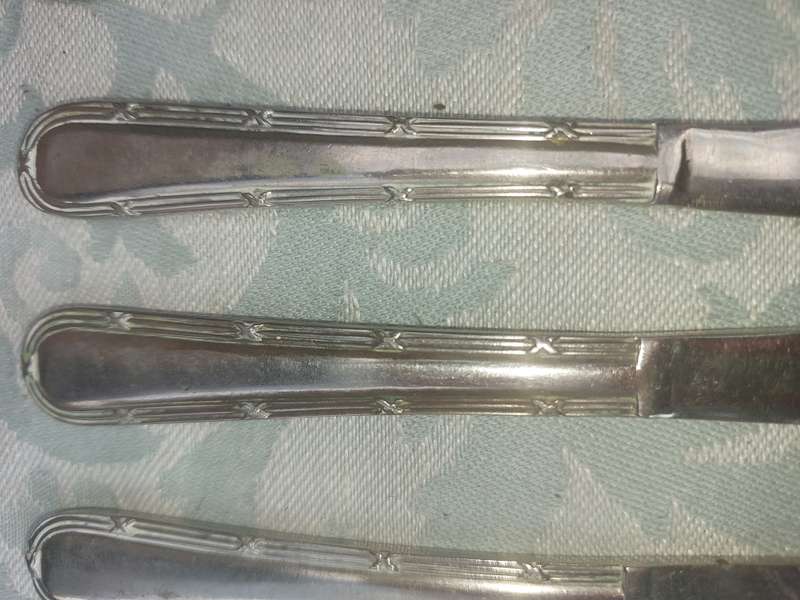 A VINTAGE SET OF NICKEL SILVER SHEFFIELD KNIVES SOLD AS IS
