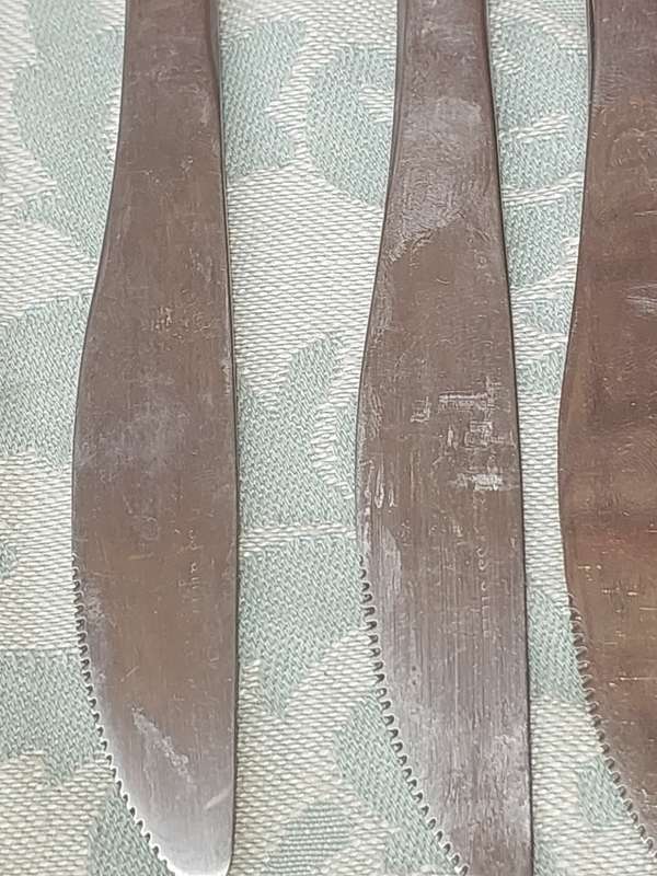 A SET OF 11 STAINLESS STEEL CUTLERY SOLD AS IS