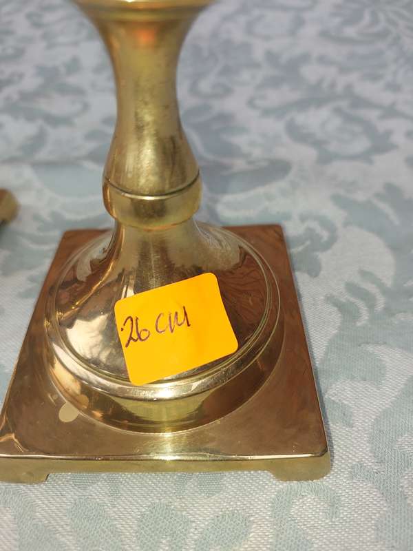 A PAIR OF BRASS CANDLE HOLDERS SOLD AS IS