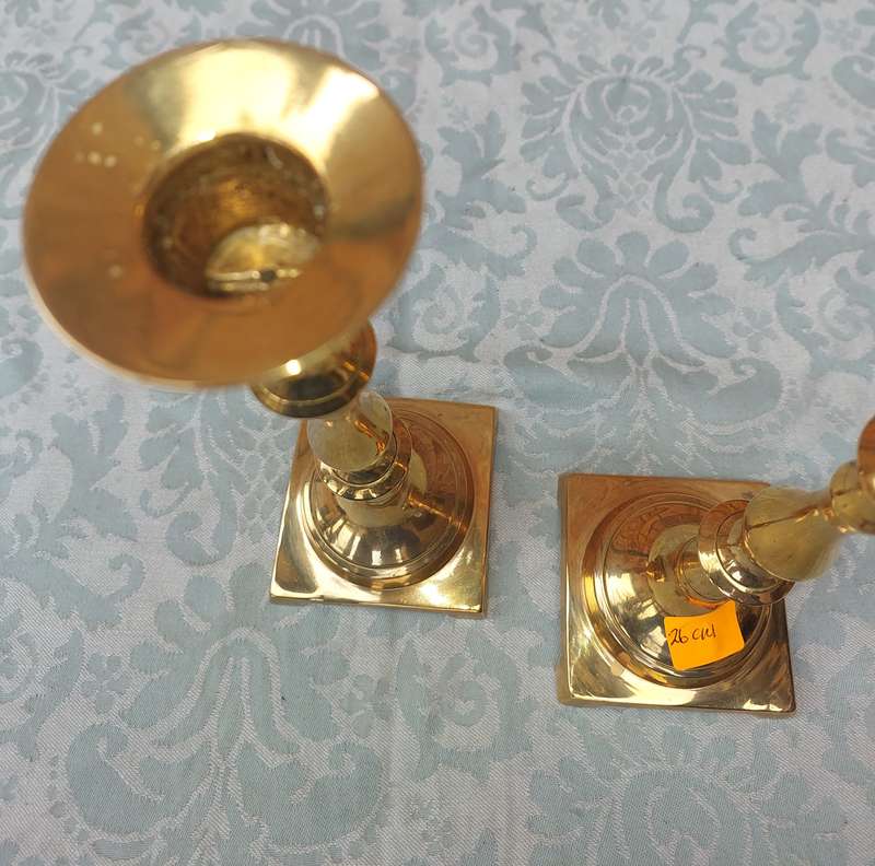 A PAIR OF BRASS CANDLE HOLDERS SOLD AS IS