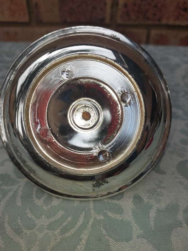 A SILVERPLATED CANDLE HOLDER SOLD AS IS