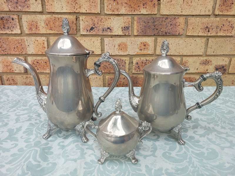 A SILVER PLATED VINTAGE TEAPOT SET SOLD AS IS
