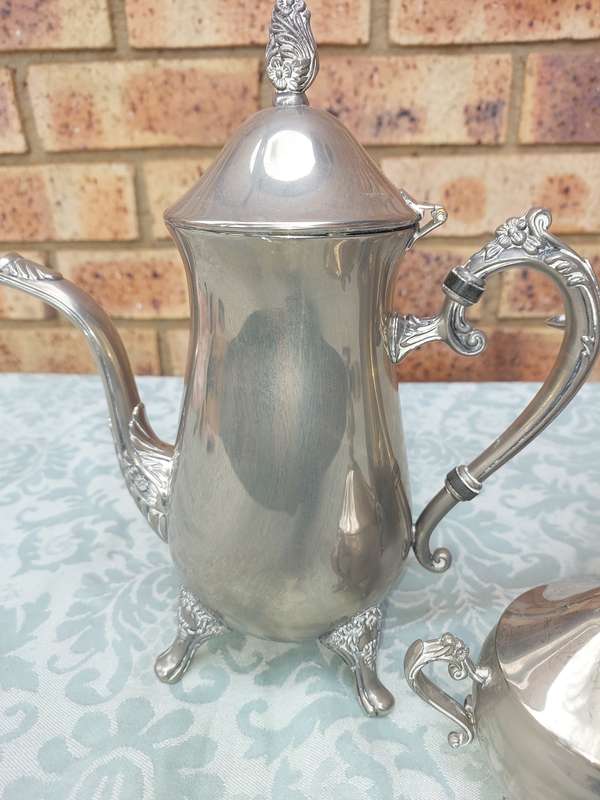 A SILVER PLATED VINTAGE TEAPOT SET SOLD AS IS