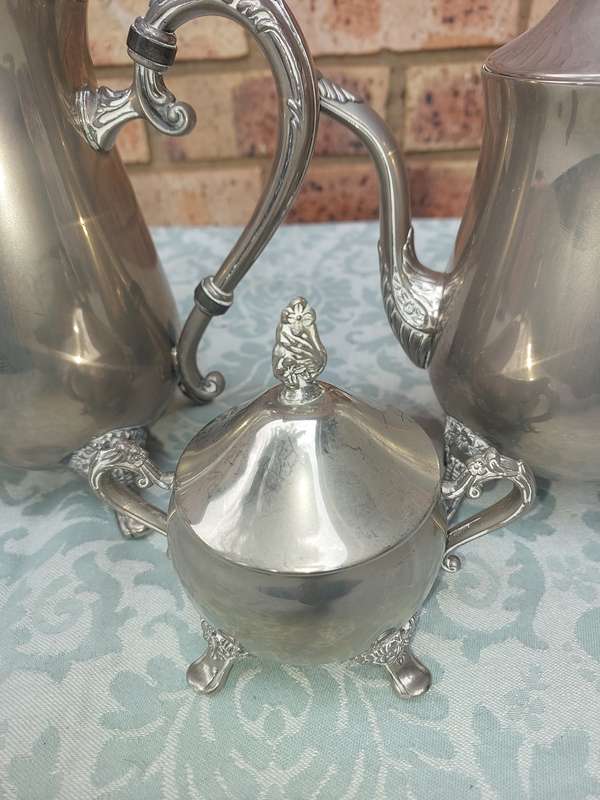 A SILVER PLATED VINTAGE TEAPOT SET SOLD AS IS