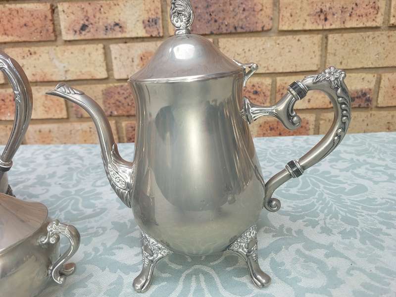 A SILVER PLATED VINTAGE TEAPOT SET SOLD AS IS