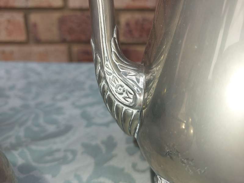A SILVER PLATED VINTAGE TEAPOT SET SOLD AS IS