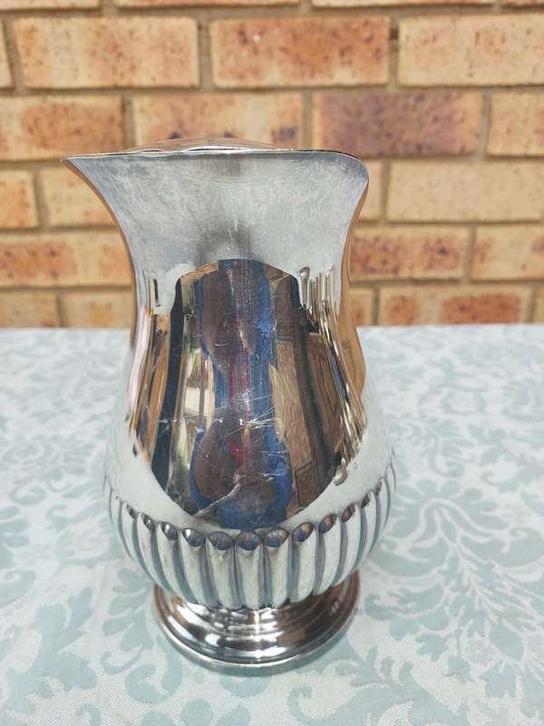 A VINTAGE EMESS SP ON B WATER JUG SOLD AS IS