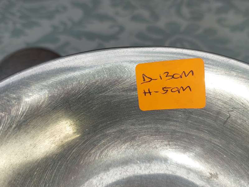 AN ALLOY ROUND SERVING BOWL WITH A LADEL SOLD AS IS