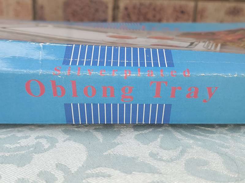 A SILVER PLATED OBLONG SERVING TRAY SOLD AS IS