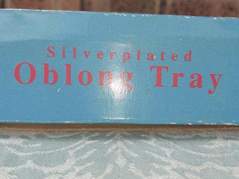 A SILVER PLATED OBLONG SERVING TRAY SOLD AS IS