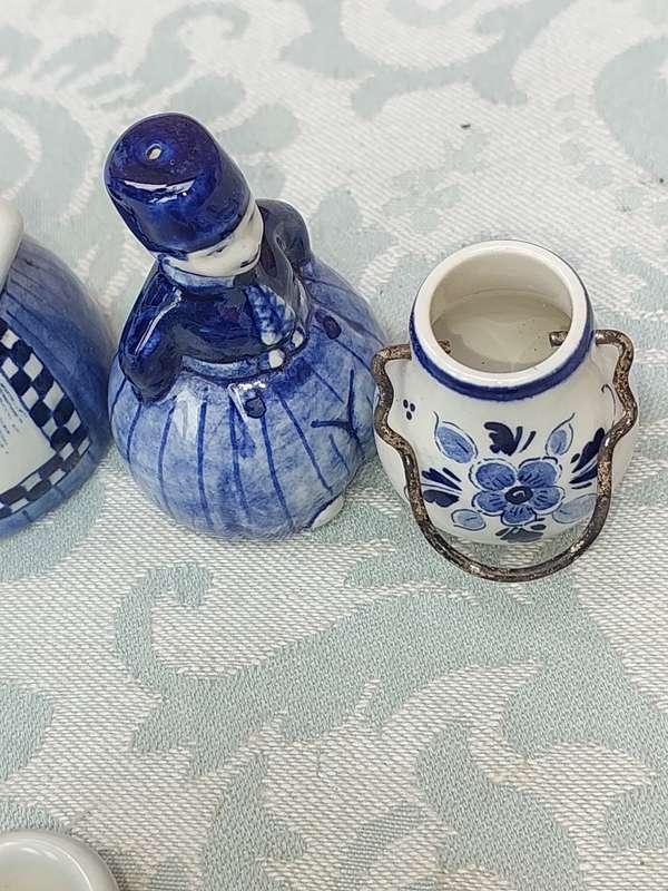A VINTAGE COLLECTION OF DELFTS BLUE FIGURINES SOLD AS IS
