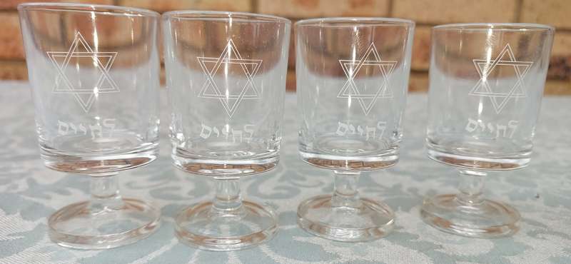 A SET OF 4 KIDDUSH GLASSES SOLD AS IS