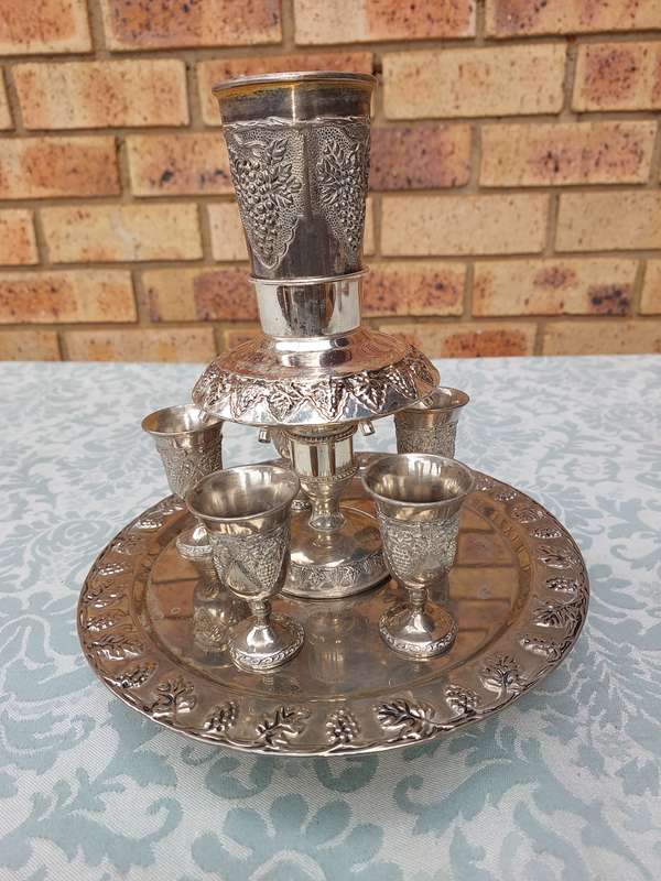 A VINTAGE KIDDUSH SET WITH ONE CUP MISSING SOLD AS IS