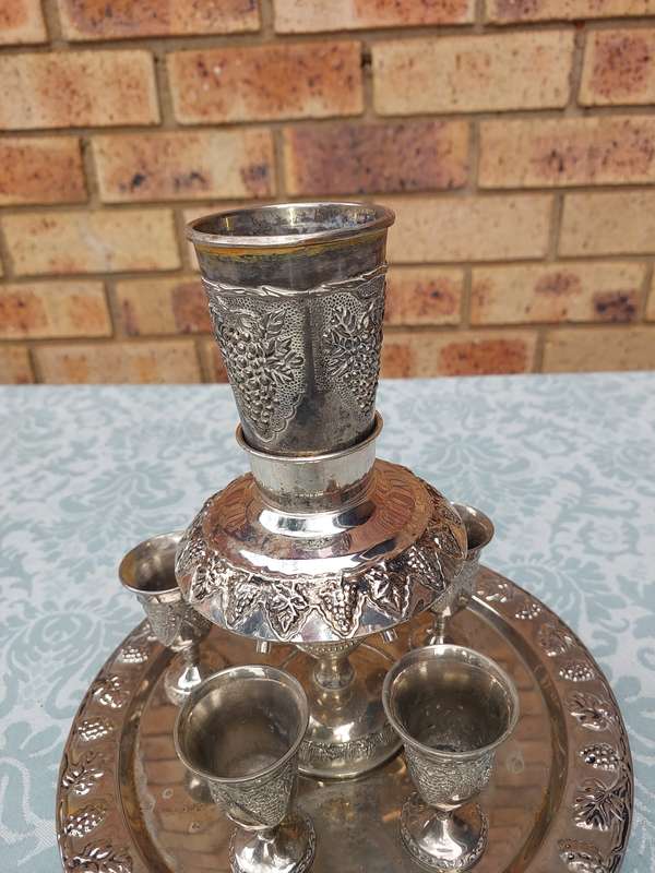A VINTAGE KIDDUSH SET WITH ONE CUP MISSING SOLD AS IS