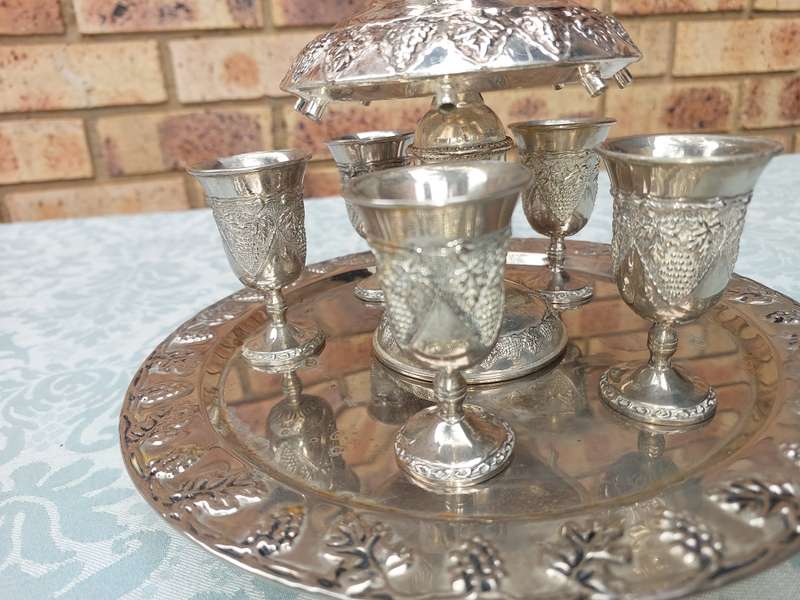 A VINTAGE KIDDUSH SET WITH ONE CUP MISSING SOLD AS IS