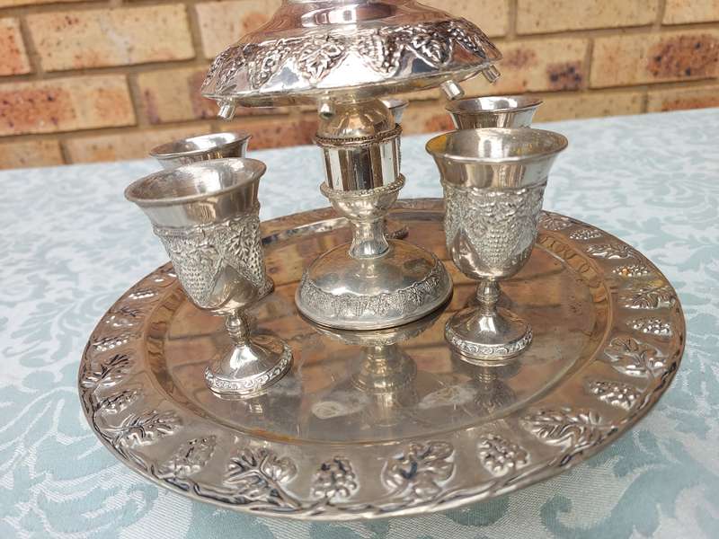 A VINTAGE KIDDUSH SET WITH ONE CUP MISSING SOLD AS IS