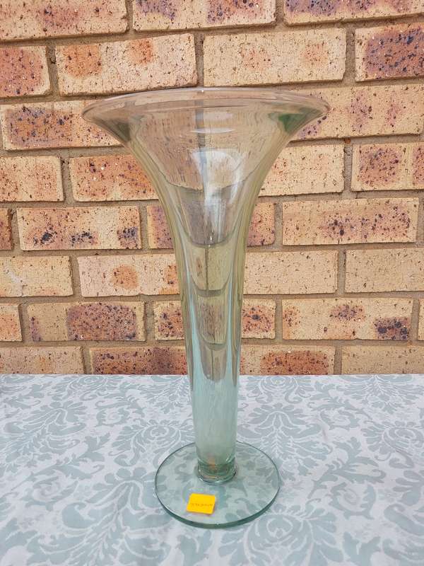 AN ART DECOR GREEN TINTED GLASS VASE SOLD AS IS