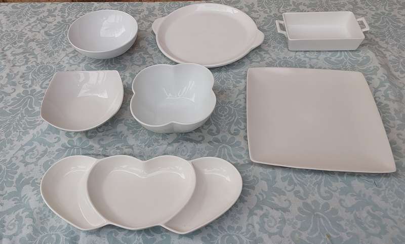 A COLLECTION OF 7 WHITE PORCELAIN SERVING PLATTERS SOLD AS IS