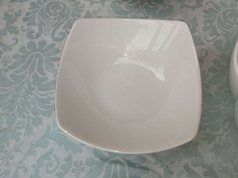 A COLLECTION OF 7 WHITE PORCELAIN SERVING PLATTERS SOLD AS IS