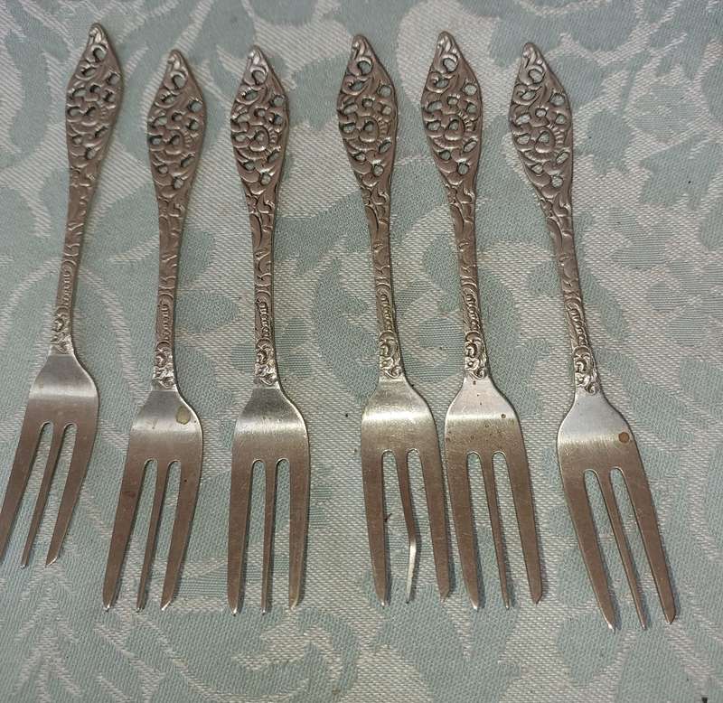 AN ART DECOR  STAINLESS STEEL SET OF CAKE FORKS SOLD AS IS