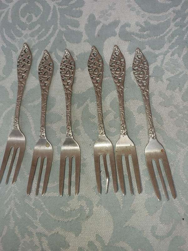 AN ART DECOR  STAINLESS STEEL SET OF CAKE FORKS SOLD AS IS