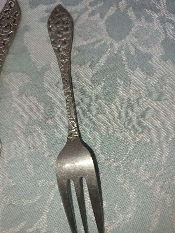 AN ART DECOR  STAINLESS STEEL SET OF CAKE FORKS SOLD AS IS