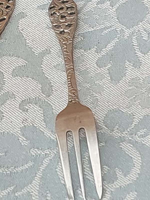 AN ART DECOR  STAINLESS STEEL SET OF CAKE FORKS SOLD AS IS